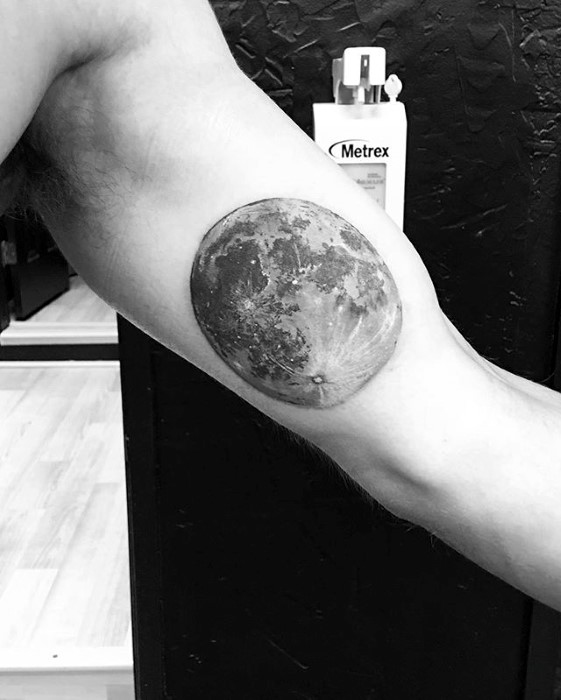 Grey and black full moon tattoo on left inner bicep for men