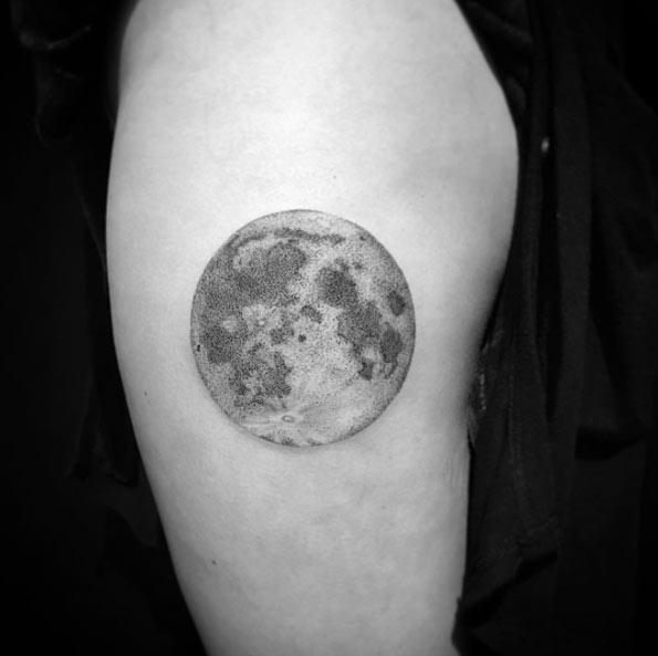 Grey and black shaded full moon tattoo on arm