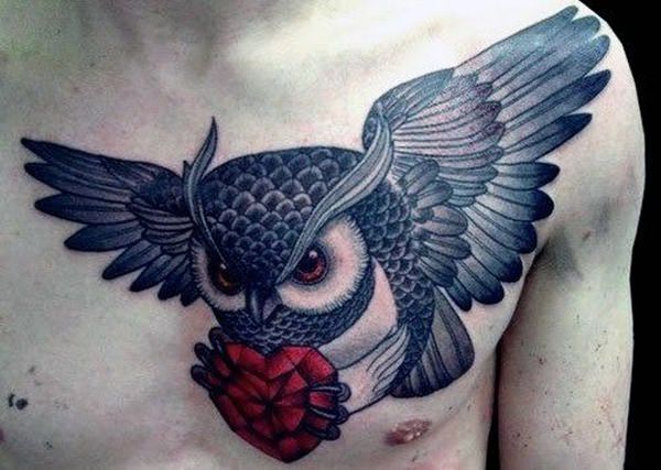 Grey ink flying owl with red ruby tattoo on men chest