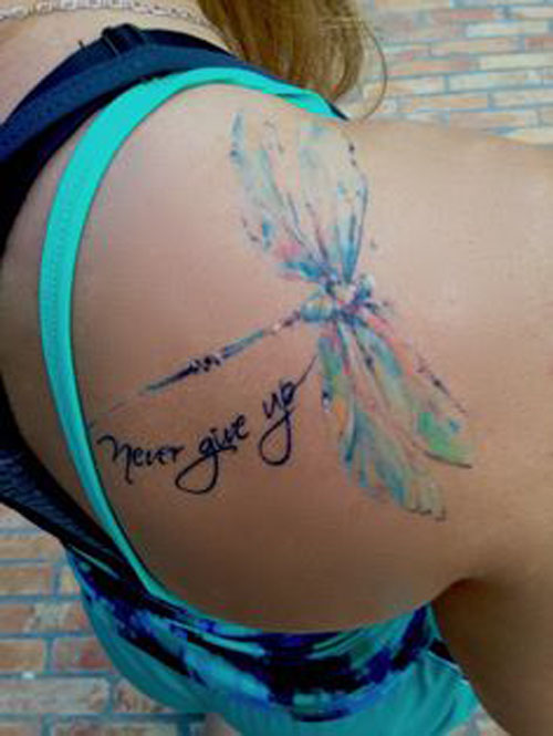 ‘Never give up’ wirh Colorful watercolor dragonfly tattoo on upper right back shoulder