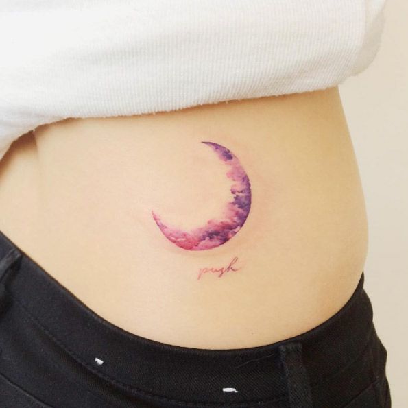 Purple half moon tattoo on above right back waist