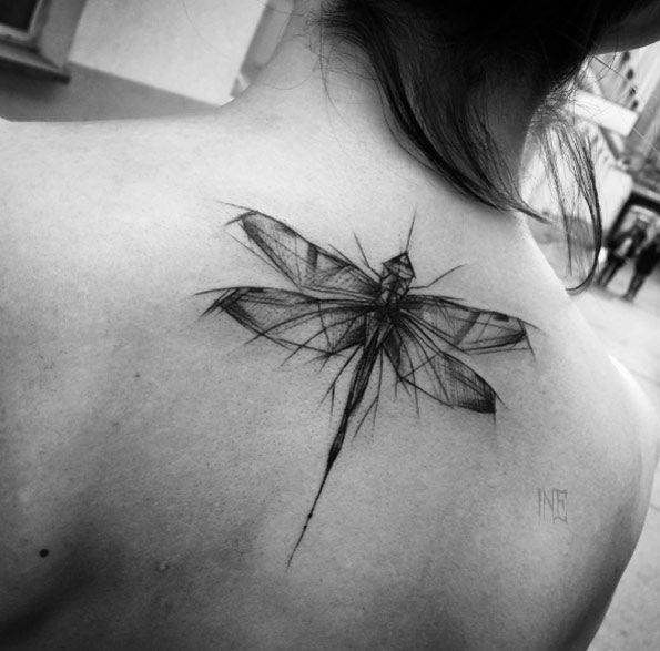 Wonderful abstract dragonfly tattoo on back by Inez Janiak
