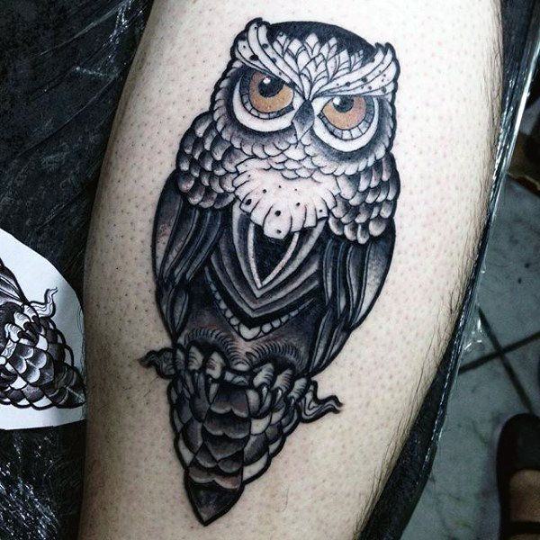 Yellow eyed black ink owl tattoo on calf