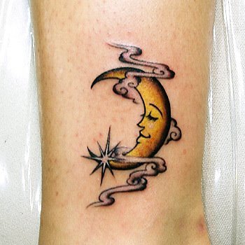 Yellow half moon tattoo on leg