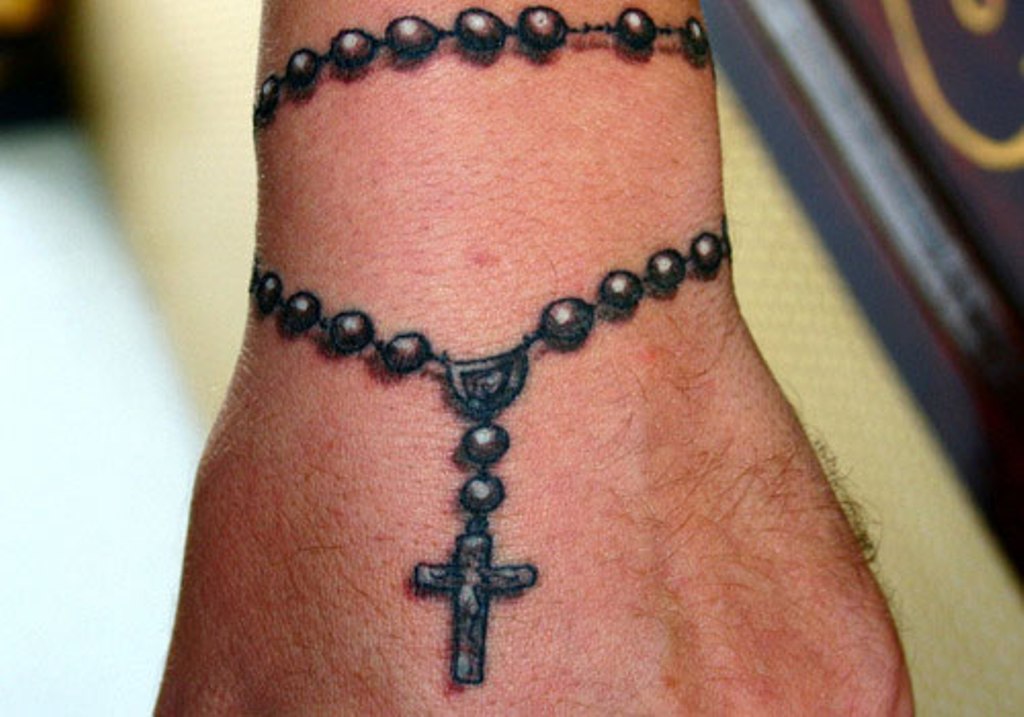 3D black realistic rosary and cross tattoo on male wrist