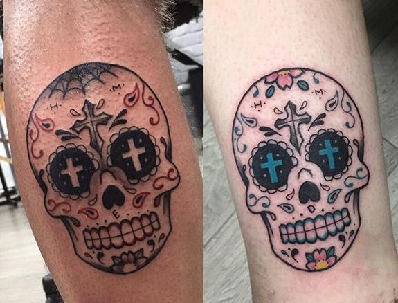 Black and colored sugar skull tattoo on arm by Sam Lyam