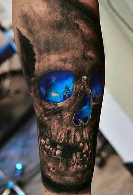 Black and deep blue realistic skull tattoo on arm for men