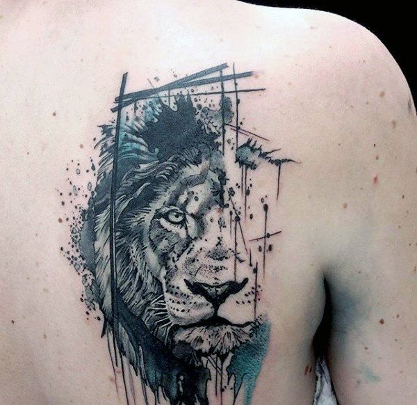 Black and green half face lion tattoo on right back