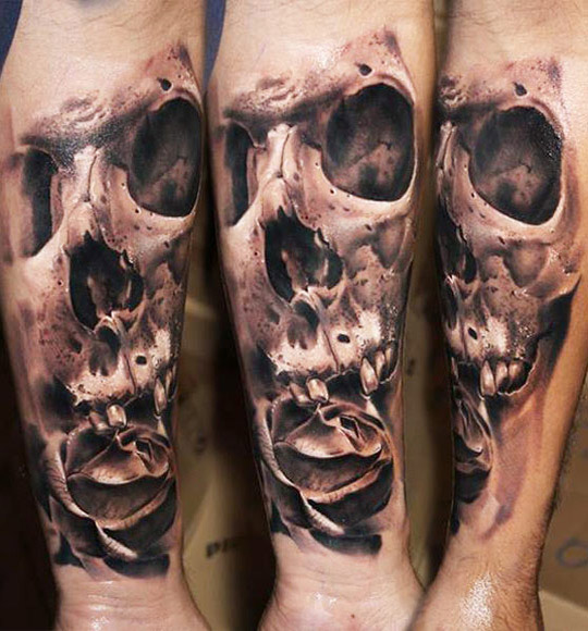 Black and grey detailed skull and rose tattoo on lower sleeve by Robert Zyla