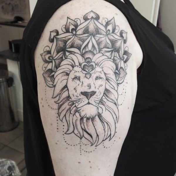 Black and grey lion tattoo design on upper sleeve