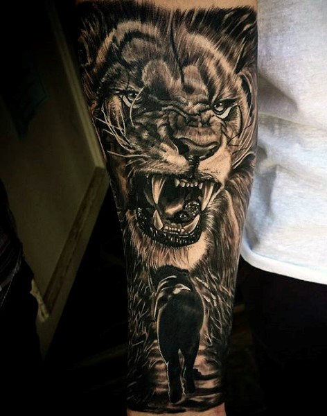 Black and grey lion tattoo on upper sleeve