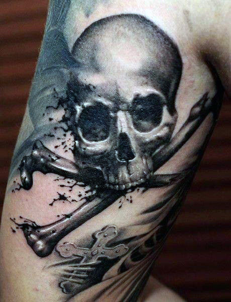 Black and grey shaded death’s head skull tattoo on upper arm for men