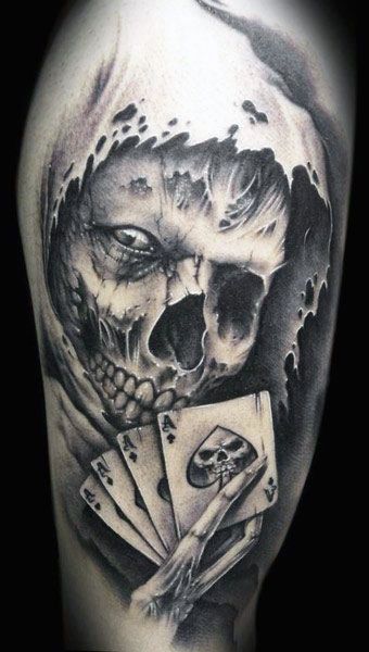 Black and grey shaded grim reaper skull tattoo on upper arm