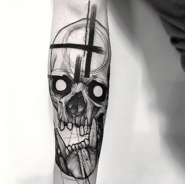 Black and grey shaded skull tattoo on sleeve