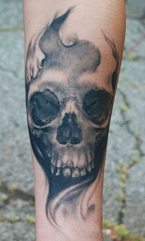 Black and grey skull tattoo on leg