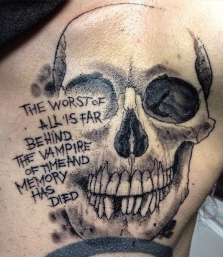 Black and grey skull tattoo with message on body for men