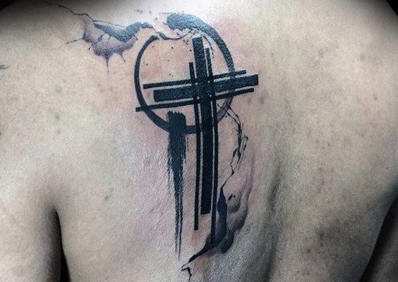 Black cross tattoo on upper left back for men