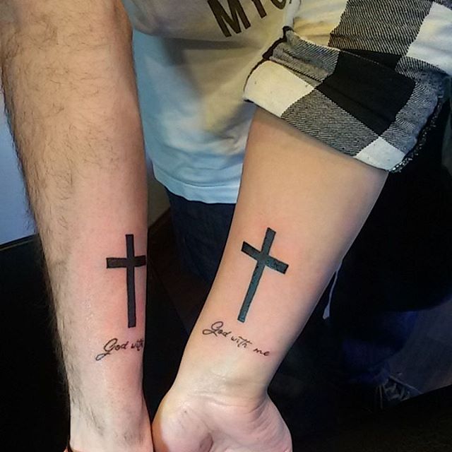 Black cross tattoo with message for couple on inner arm