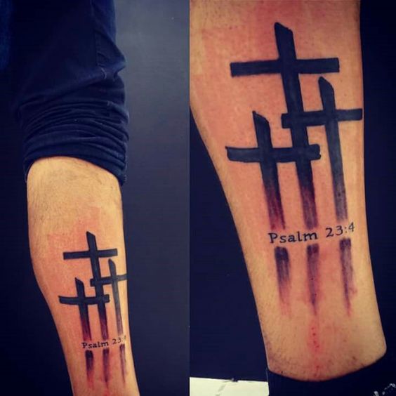 Black cross tattoos on lower arm for men