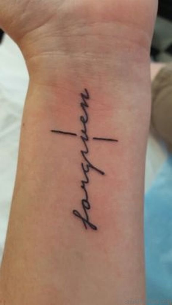 Black forgiven cross tattoo on inner arm