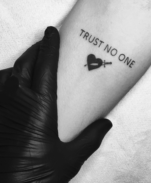 Black heart break trust no one tattoo on inner forearm