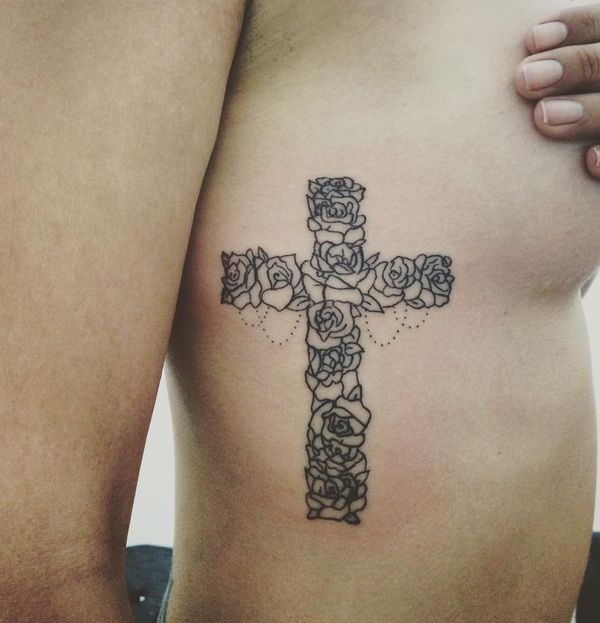 Black rose cross tattoo on upper right body for women