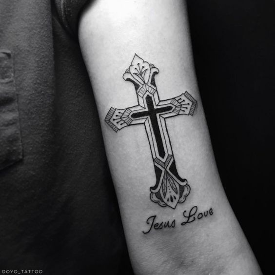 Black simple cross with message tattoo design on inner arm