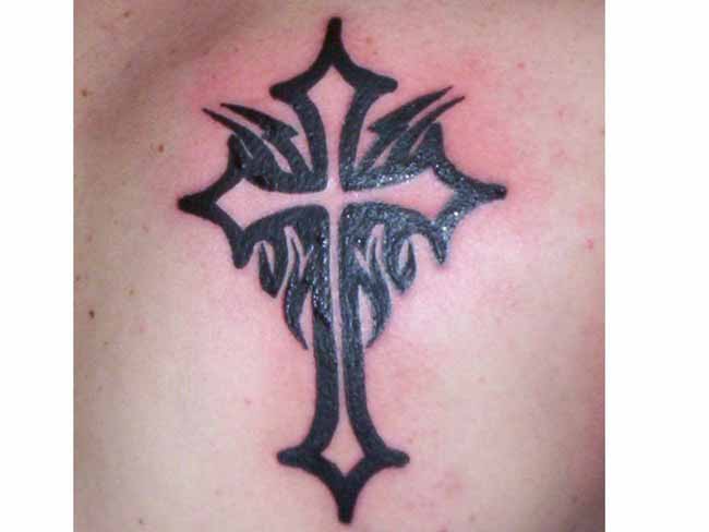 Black tribal cross tattoo on body