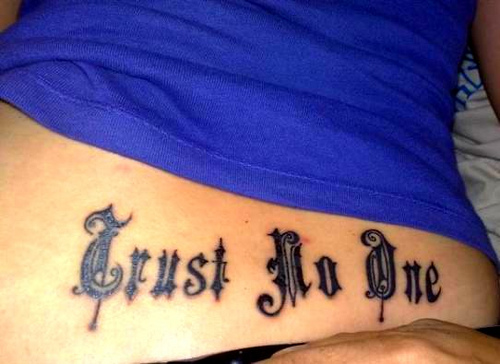 Black trust no one tattoo on body