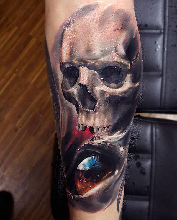 Colored eye and skull tattoo on arm
