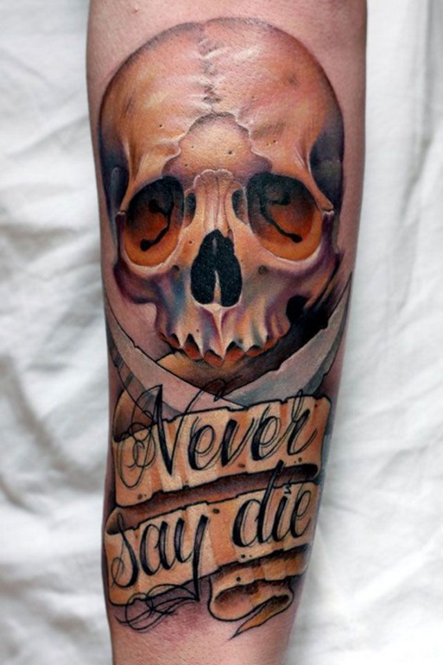 Colored never say die skull tattoo on inner arm