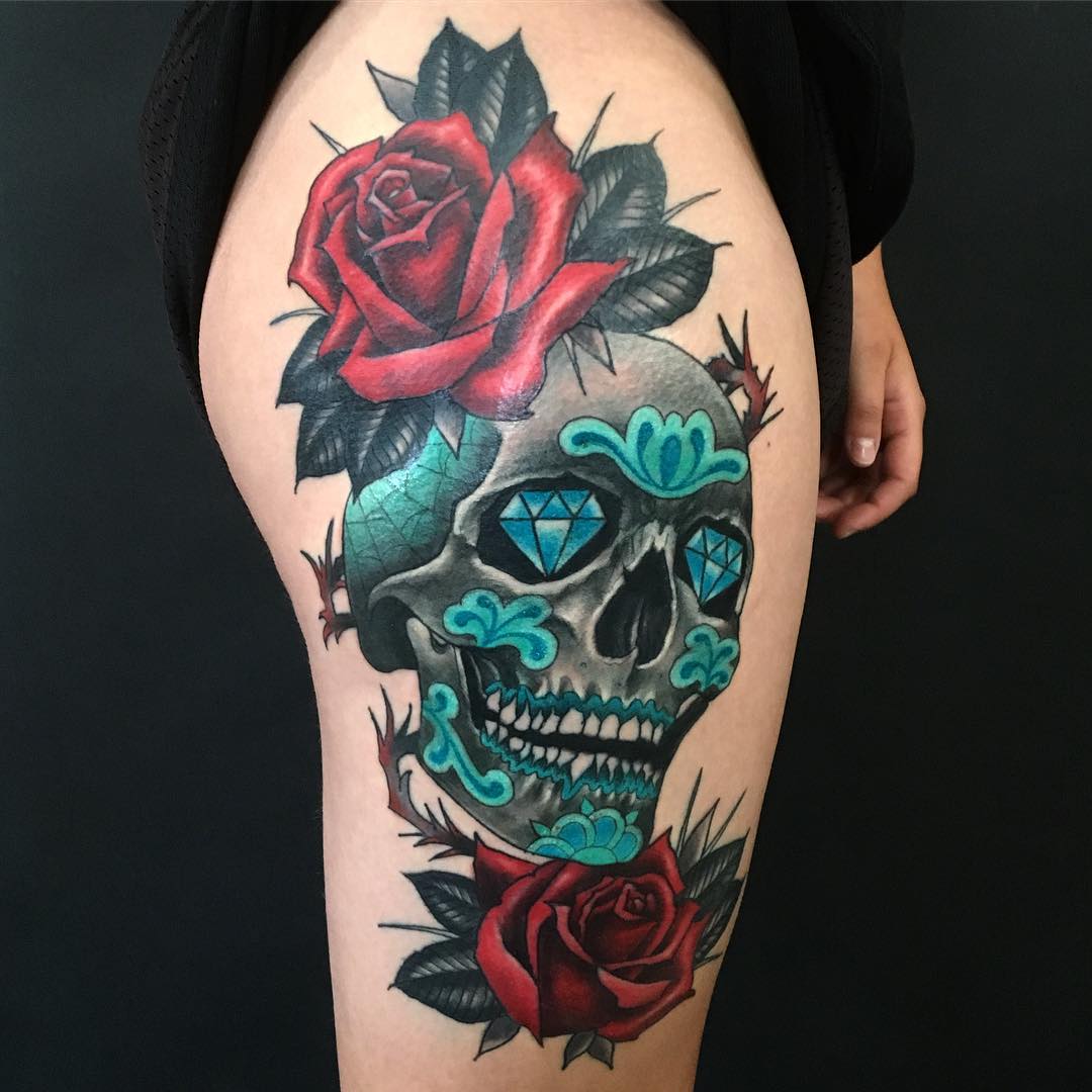 Colored skull and rose tattoo on right lower body for women