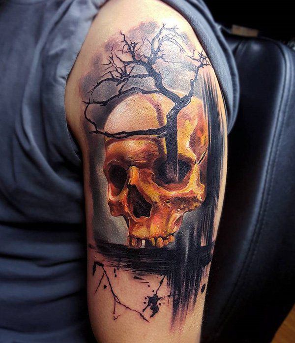 Colored skull with tree tattoo on upper arm