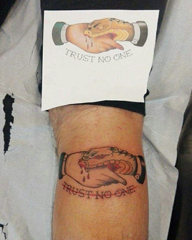 Colored snake shake hand trust no one tattoo on arm