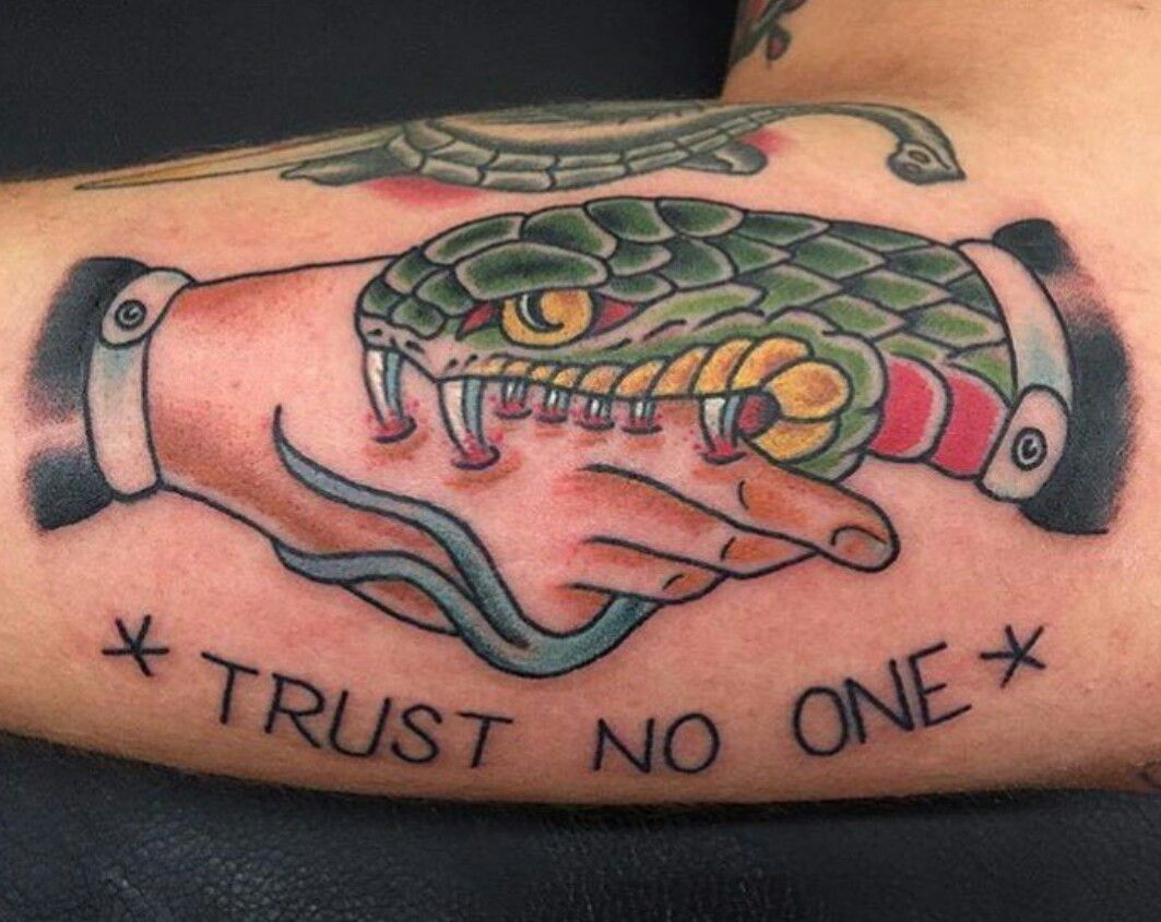 Colored trust no one snake hand shake tattoo on forearm