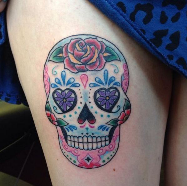 Colorful sugar skull tattoo on right thigh for women