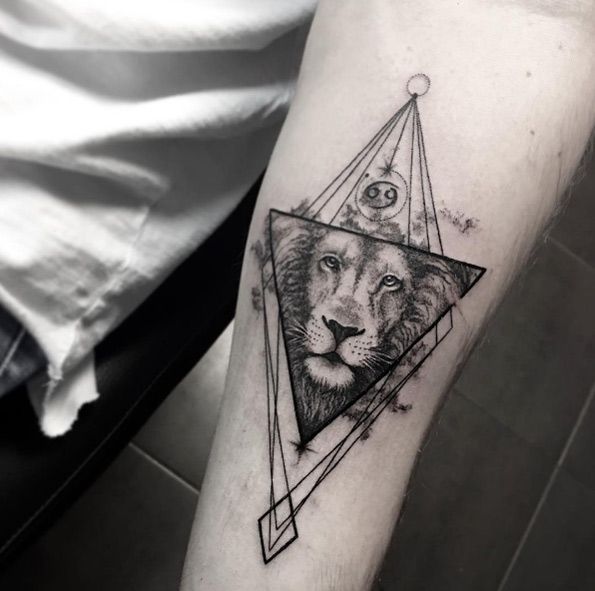 Geometric lion tattoo on forearm by Sara Reichardt