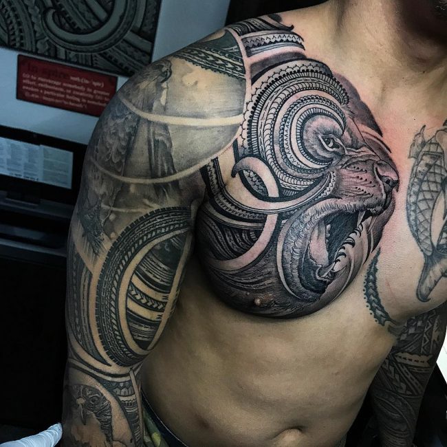 Grey roaring lion tattoo on right chest and sleeve