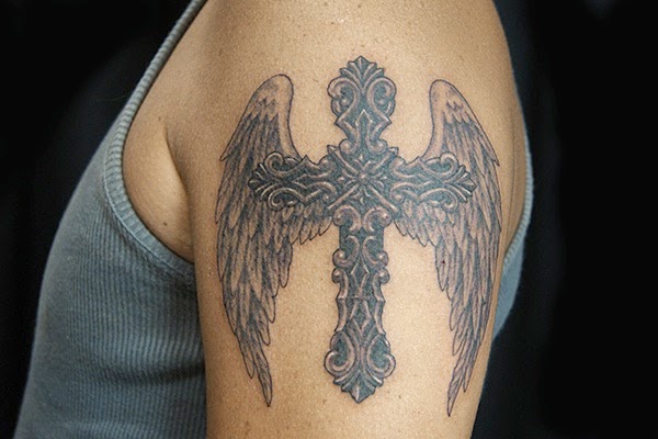 Grey shaded cross wings tattoo on upper arm