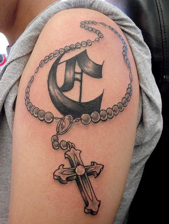 Grey shaded cross with rosary tattoo on upper left arm for men