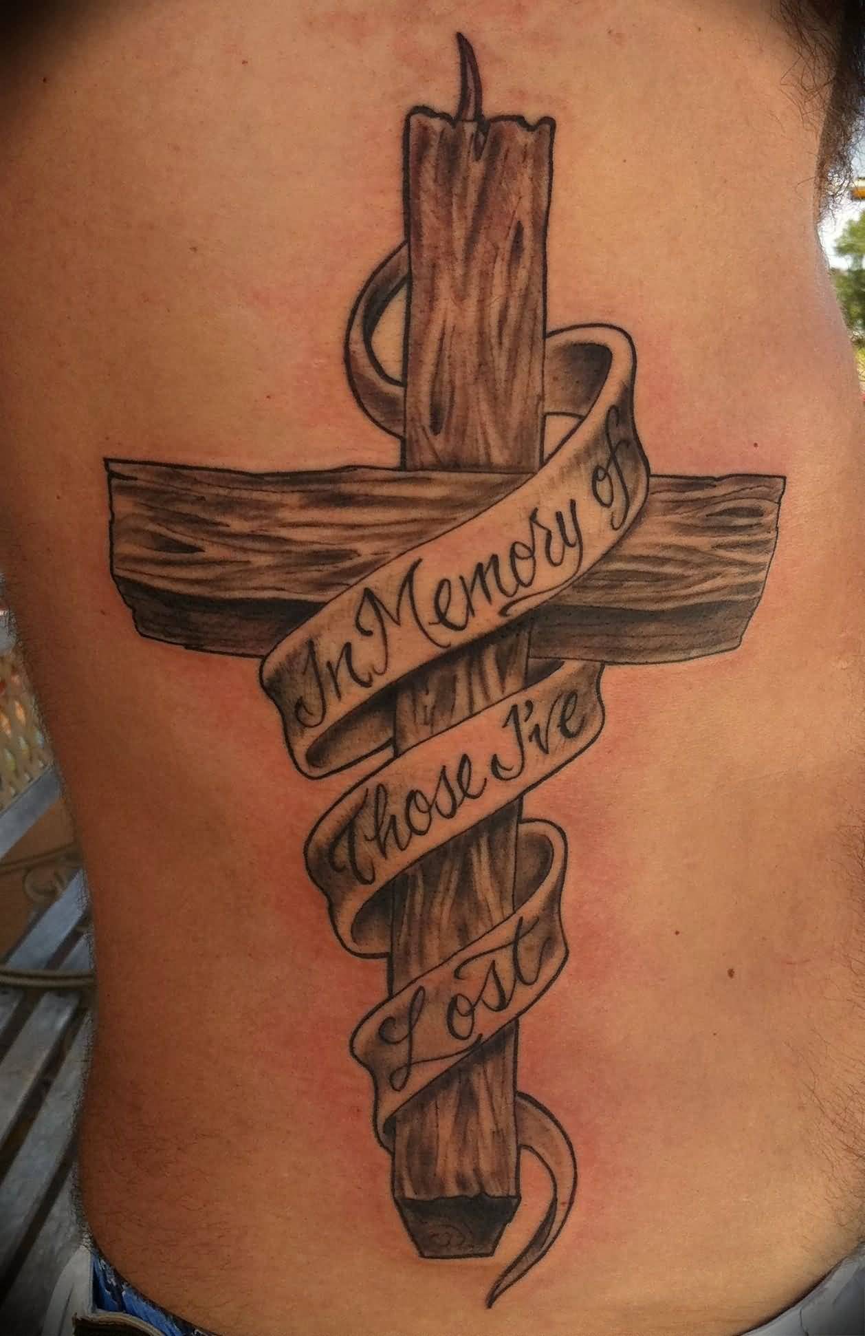 Grey shaded wooden cross with message tattoo on right siderib