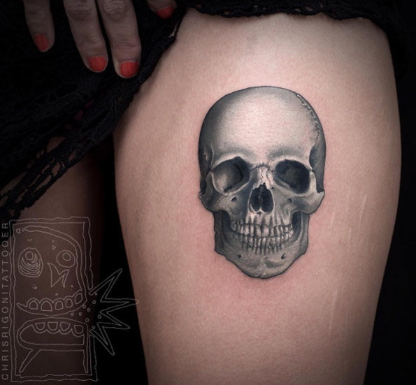 Grey skull tattoo on thighs