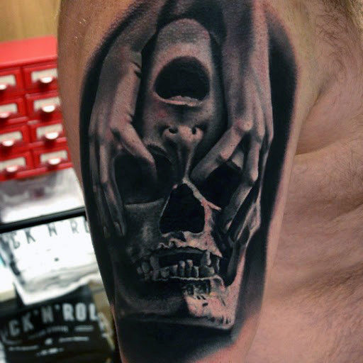 Men’s Shoulder Dangerous Skull In Hands Tattoo