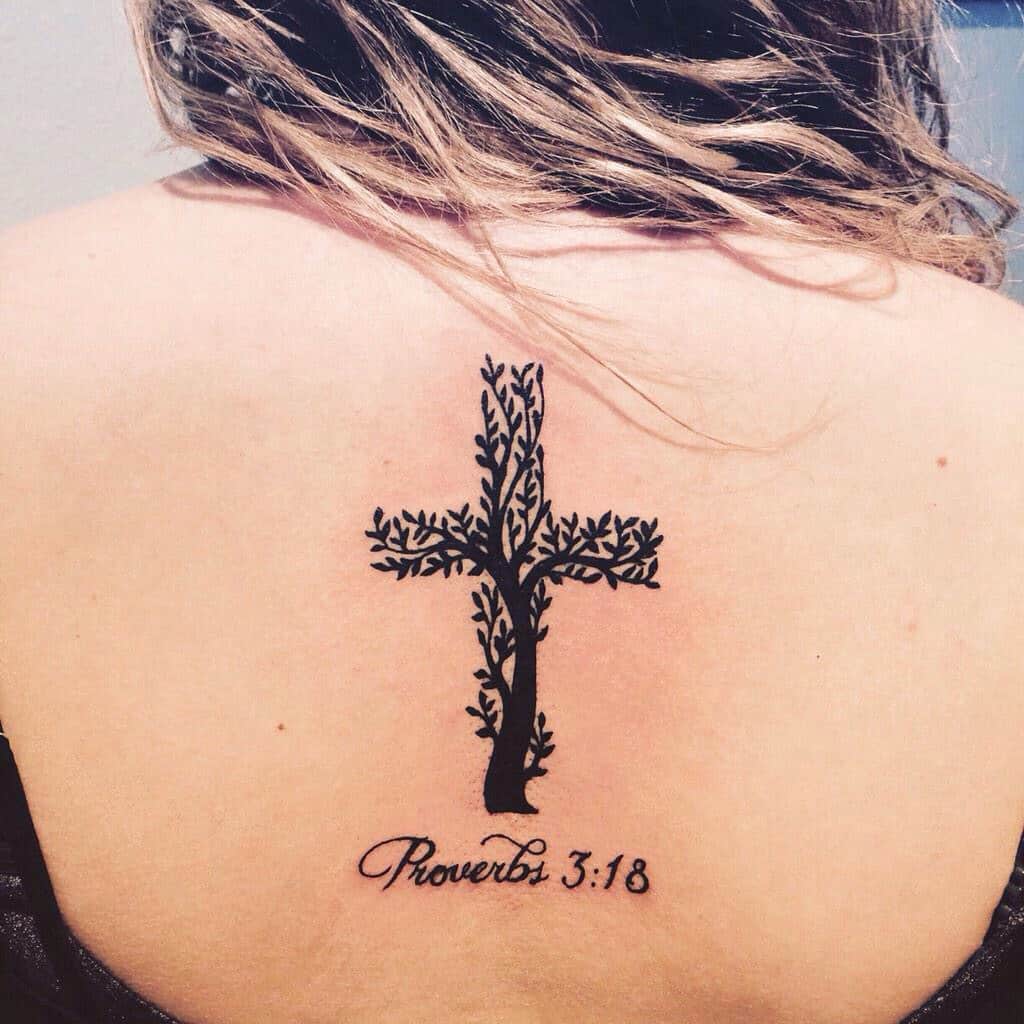 Women’s back tree cross tattoo