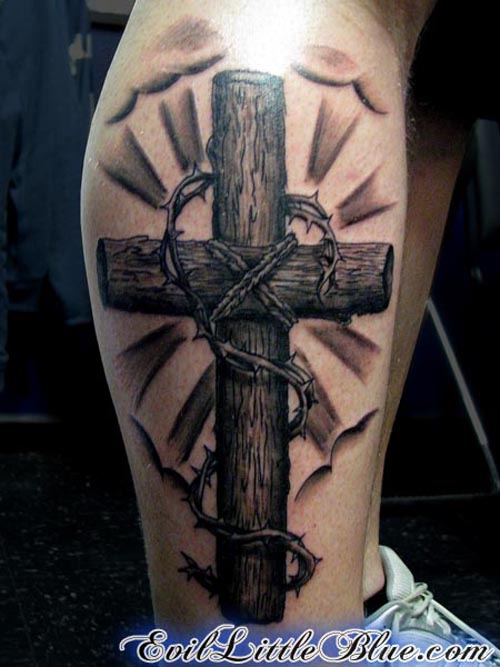Wooden Cross with barbed wire tattoo on leg