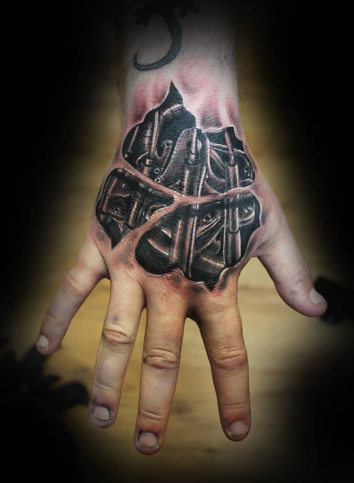Black Bio-mechanical tattoo on upper hand