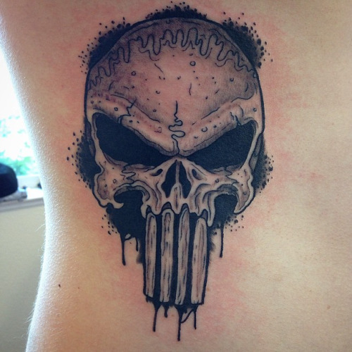 Black and grey shaded punisher skull tattoo on body