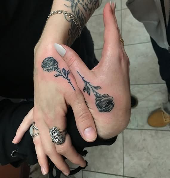 Black and grey shaded rose couple tattoo below right upper thumb