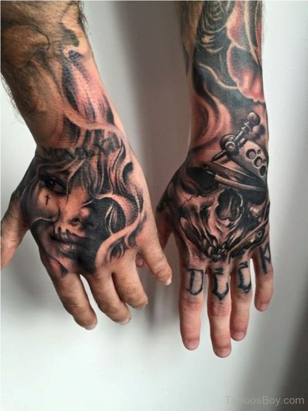 Black and grey shaded skull tattoo on upper hands