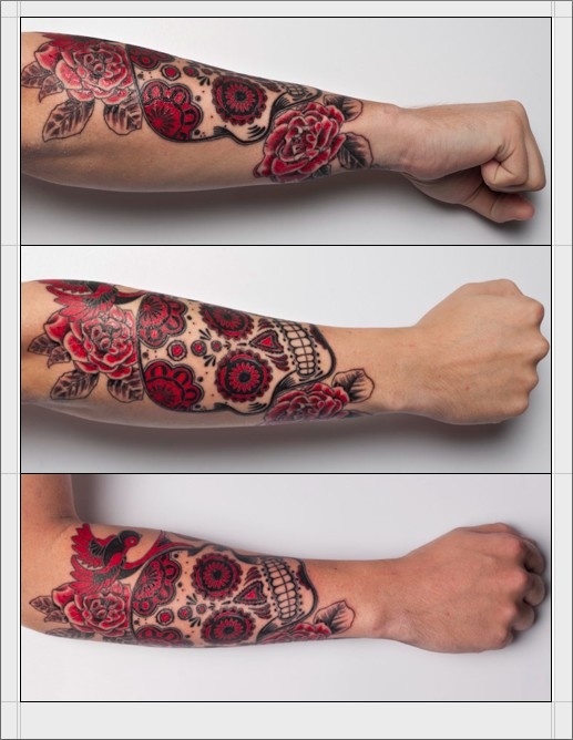 Black and red sugar skull with roses tattoo on forearm
